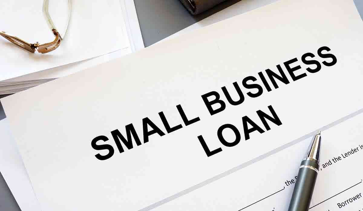 Small business owner discussing loan options with American Business Lending representative